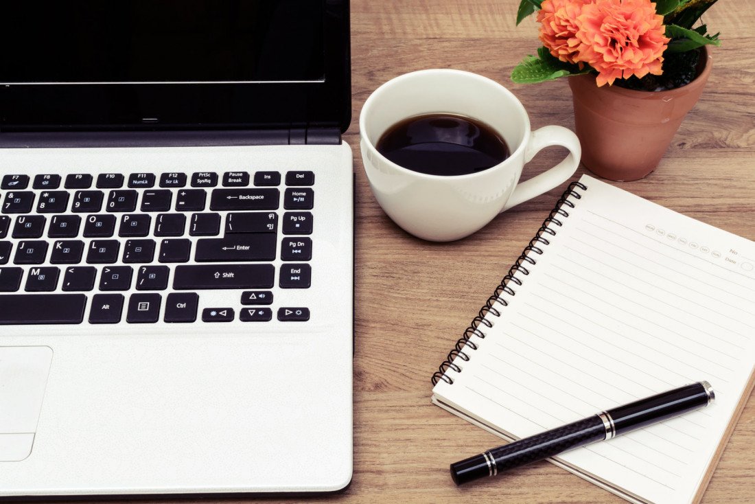 37219545 - laptop and cup of coffee with flower on desk, vintage style